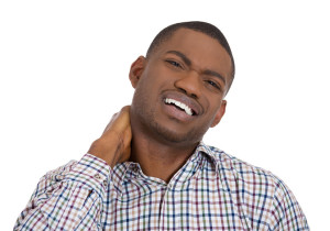 Stressed young man having neck pain